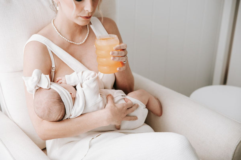 Mother breastfeeding her baby drinking hydramama