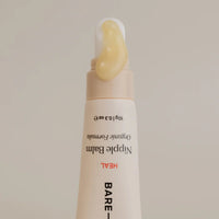 Bare Mum Nipple Balm tube with visible cream on a beige background