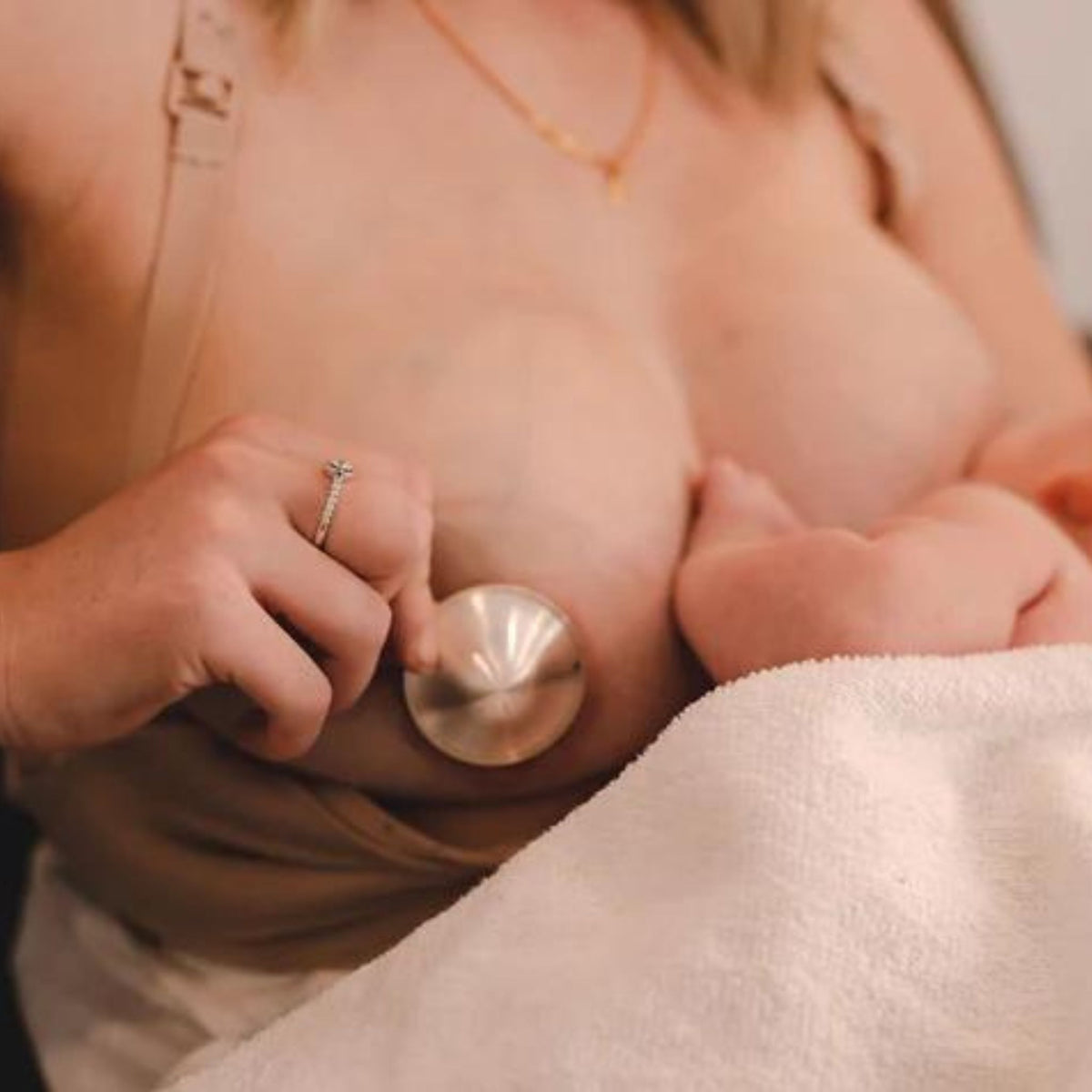 Mother using a sterling silver nursing cap