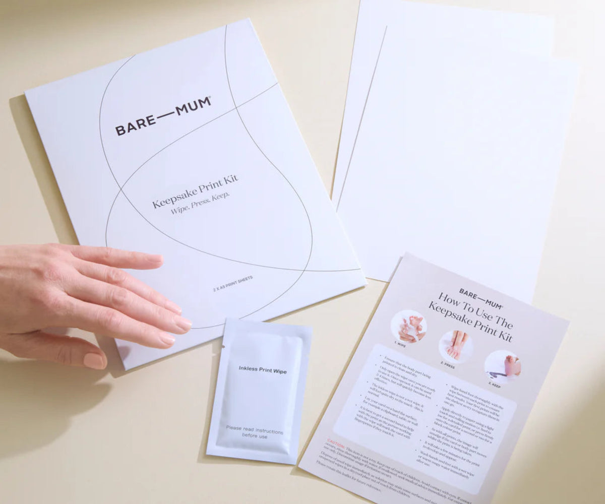 Bare Mum newborn keepsake print kit with instructions and a hand holding a sheet of paper.