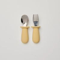 Rommer kids cutlery with yellow handles on a white background