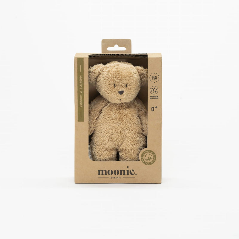 Plush teddy bear in a cardboard box with 'moonie' branding on a white background