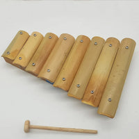 Wooden xylophone with mallet on a white background