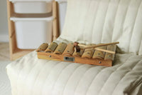 Wooden xylophone on a white cushion with a blurred background