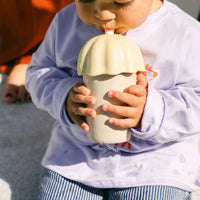 Child drinking from a rommer children's smoothie cup
