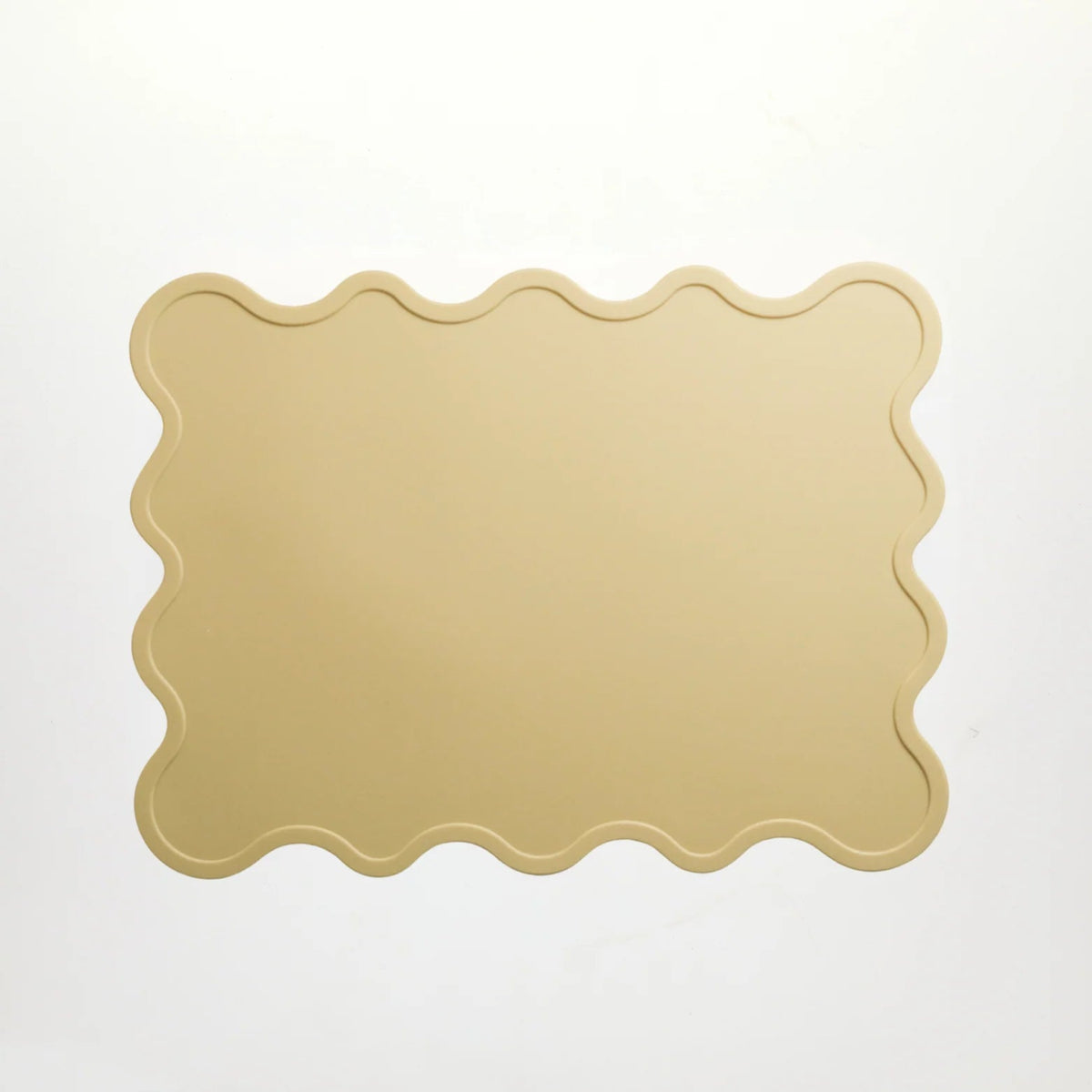Yellow scalloped-edge silicone placemat designed by Rommer