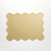 Yellow scalloped-edge silicone placemat designed by Rommer